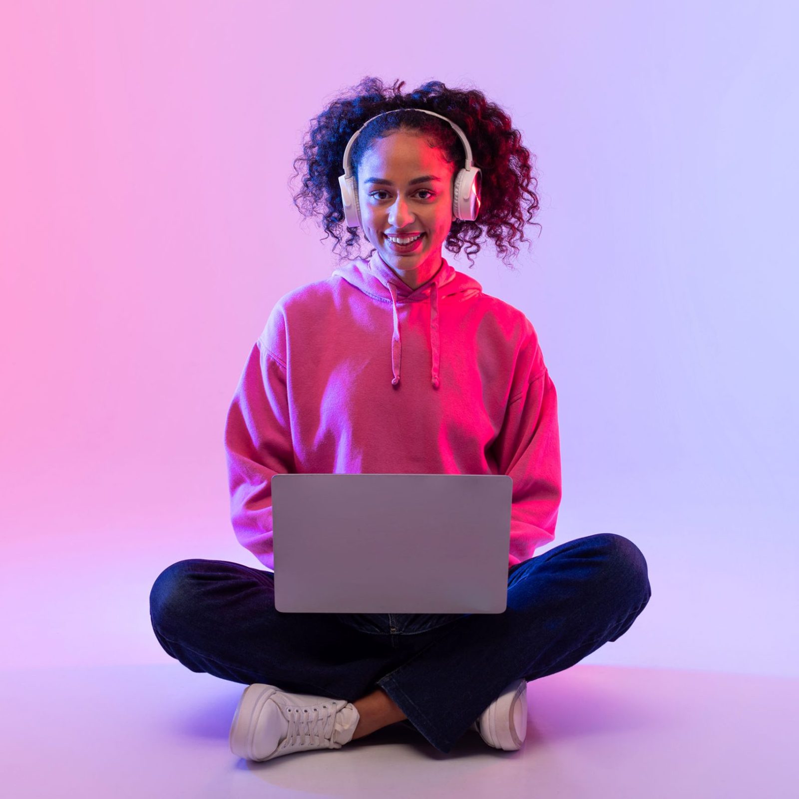 smiling-young-woman-with-laptop-and-headphones-sit-2024-03-13-18-37-19-utc